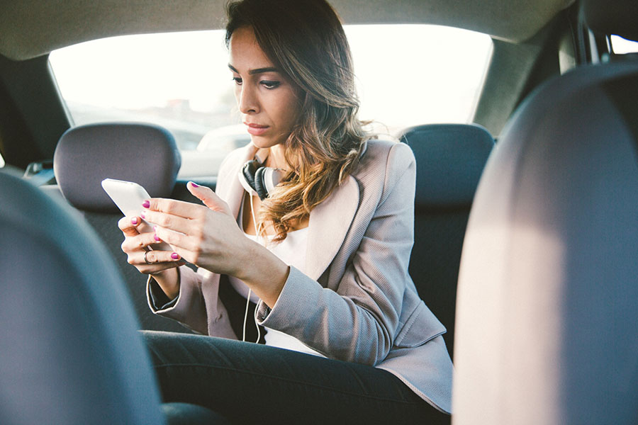 getty-woman-in-car-with-phone.jpg